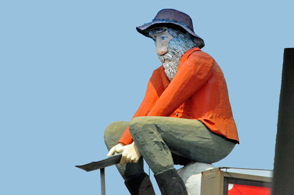 man statue on top of a building